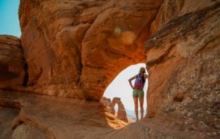 Woman standing in natural arch