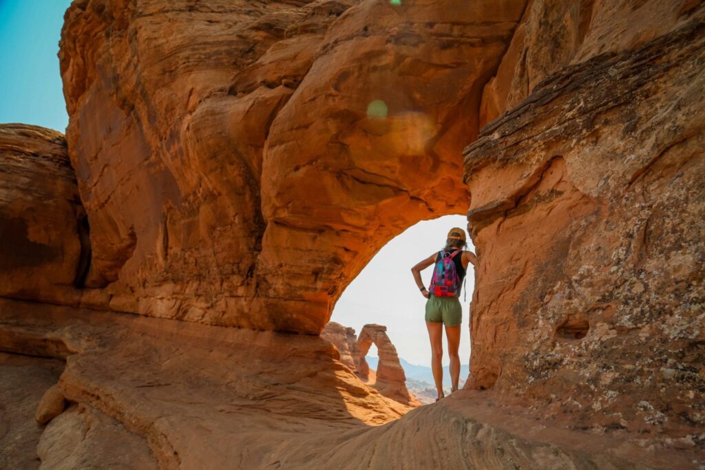 Woman standing in natural arch
