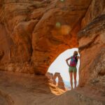 Woman standing in natural arch