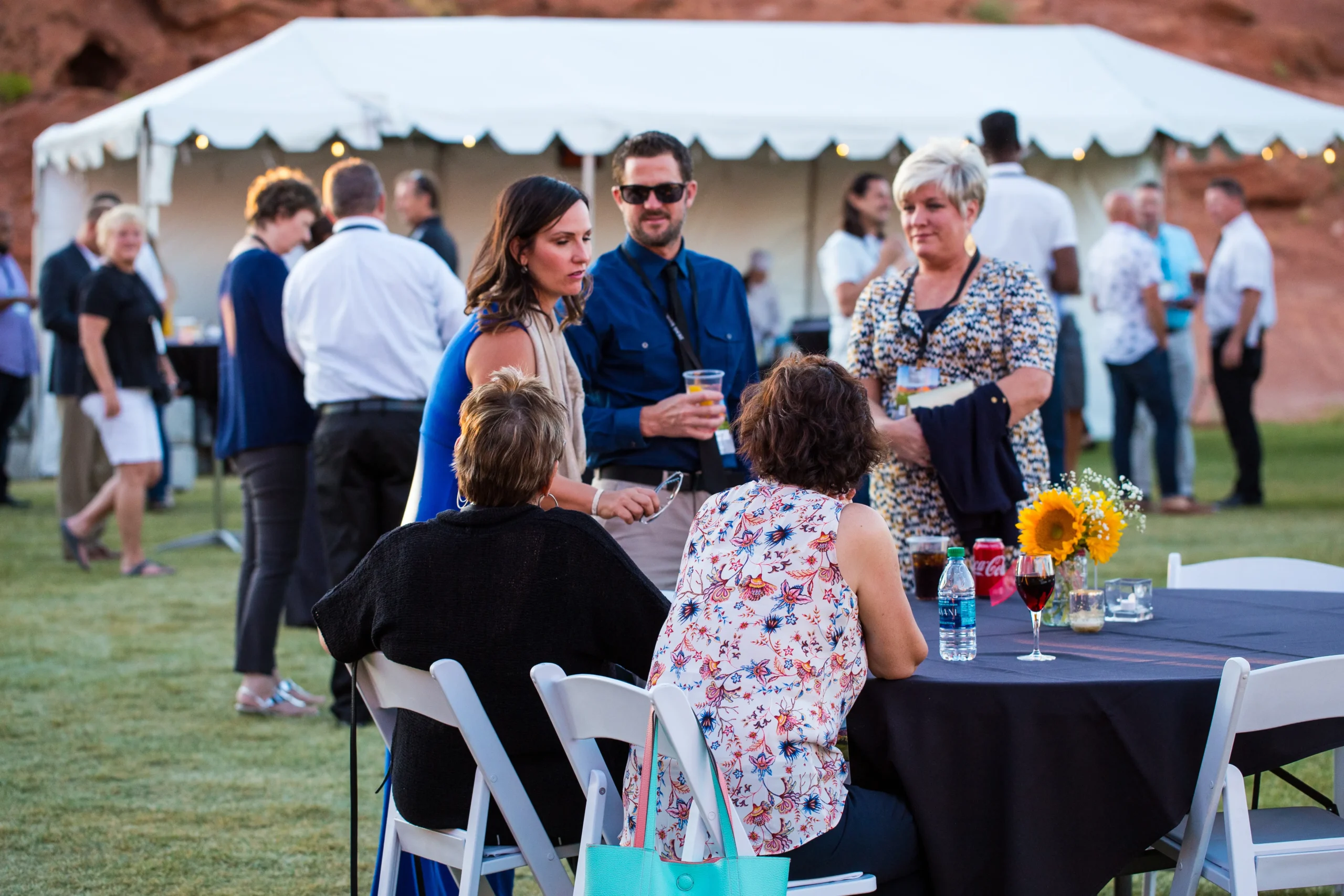 A group of people gathered at a table during a corporate event at Sand Hollow Resort.