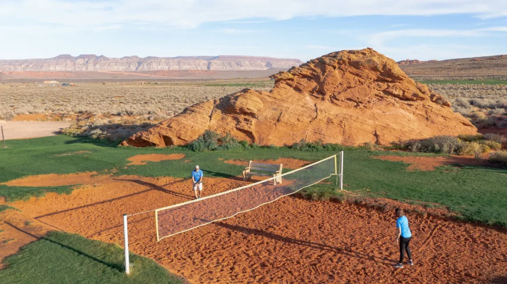 Couple enjoying a fun game of sand volleyball at Sand Hollow Resort